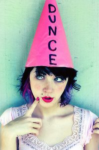 Photo of a cute girl in a dunce hat